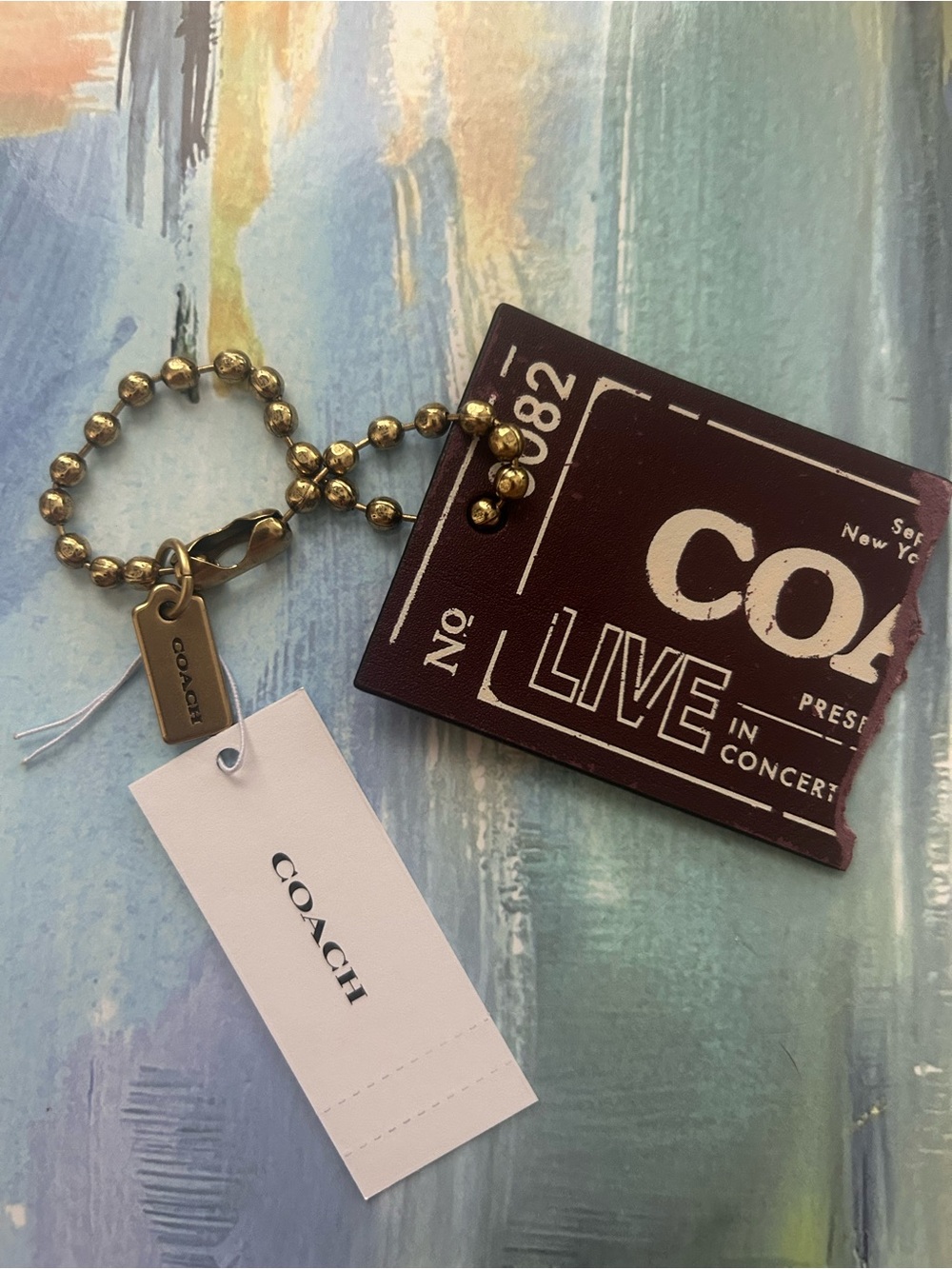 Coach Gold-Tone Ball Chain Key Tag with Brown Ticket Charm